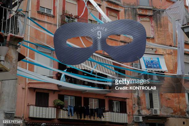 Blue and white ribbons and ornaments such as the mask of Napoli striker Victor Osimhen decorate the streets to celebrate Napoli's Serie A title....