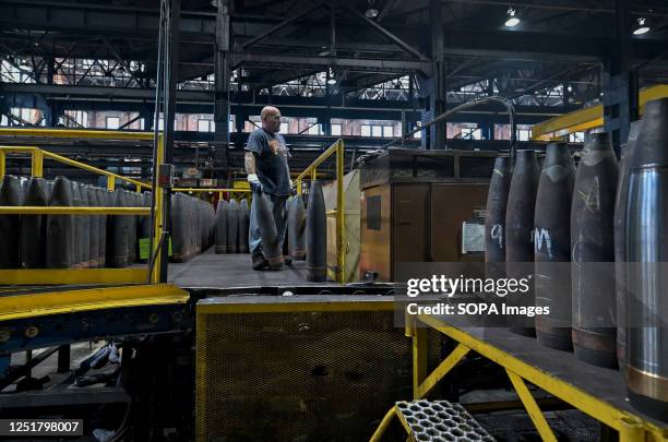 An employee moves a shell in the process of becoming ammunition. The Scranton Army Ammunition Plant held a media day to show what they make. The...