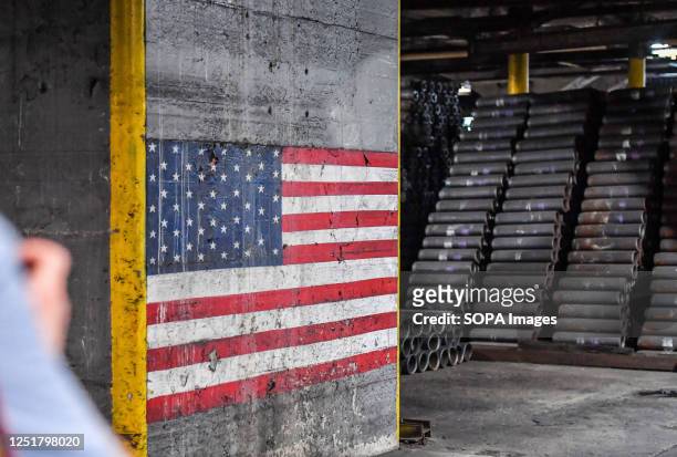 An American flag painted on the wall of the artillery factory next to cylinders used to make shells. The Scranton Army Ammunition Plant held a media...