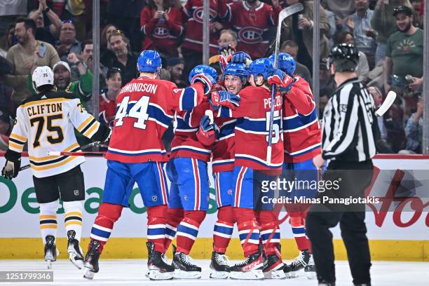 Lucas Condotta of the Montreal Canadiens celebrates his first career NHL goal in his first ever game with teammates during the first period against...