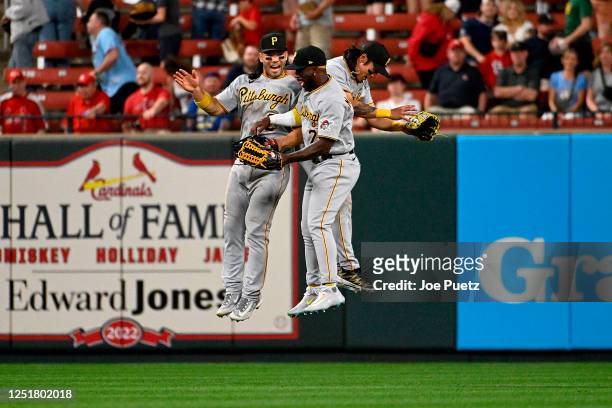 Connor Joe, Ji Hwan Bae and Andrew McCutchen of the Pittsburgh Pirates celebrate their team's 5-0 victory over the St. Louis Cardinals at Busch...