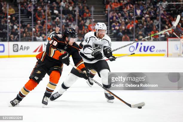 Max Jones of the Anaheim Ducks skates with the puck with pressure from Vladislav Gavrikov of the Los Angeles Kings during the first period at Honda...