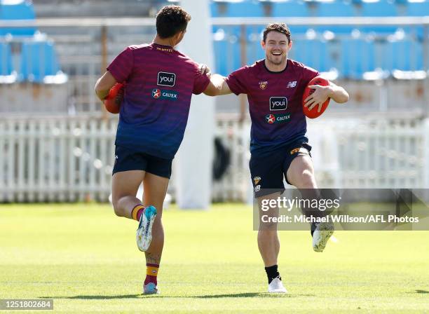 Cam Rayner and Lachie Neale of the Lions stretch during the Brisbane Lions training session at Summit Sports Park on April 14, 2023 in Adelaide,...