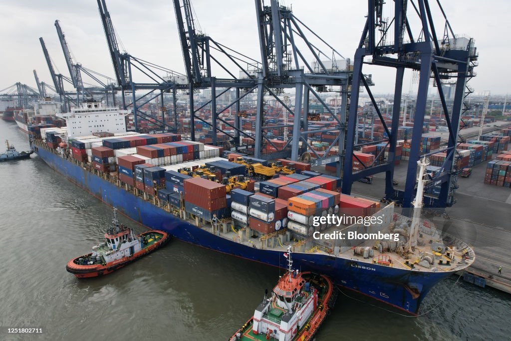 Container Tanjung Tug boats guides the Lisbon container ship into Tanjung Priok Port in ...