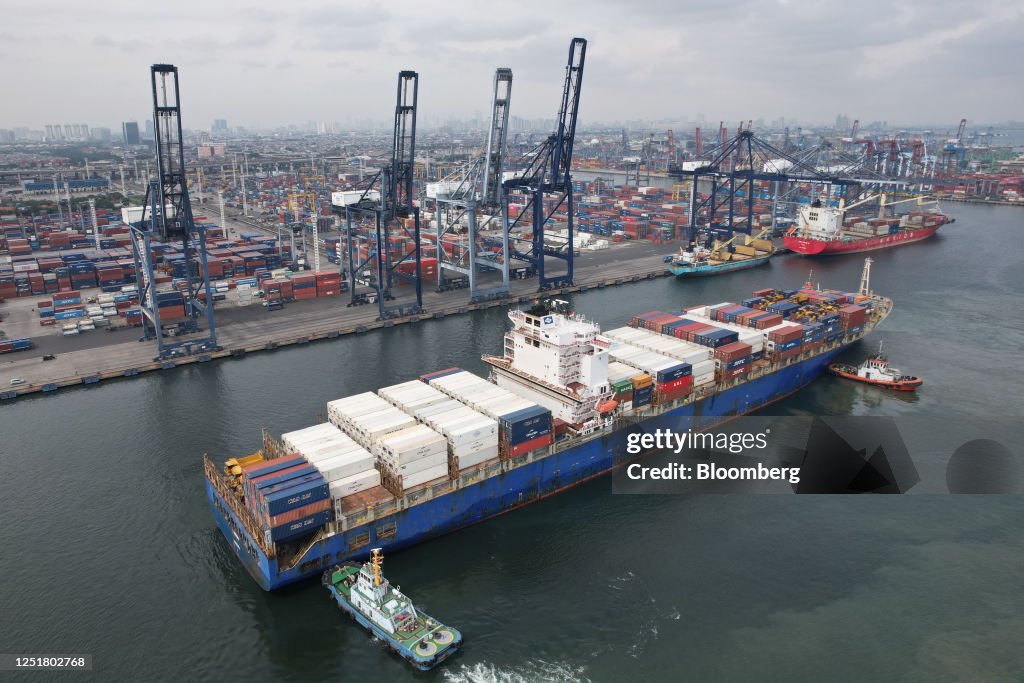 Container Tanjung Tug boats guides the Lisbon container ship into Tanjung Priok Port in ...