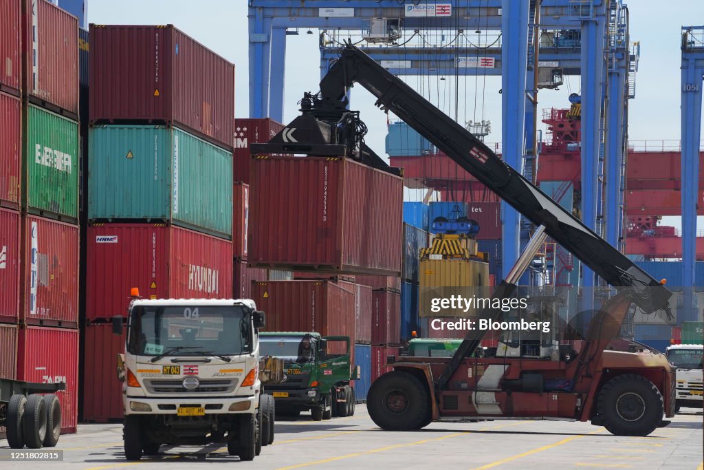 Container Tanjung A reach stacker moves a shipping container in the IPC Container ...