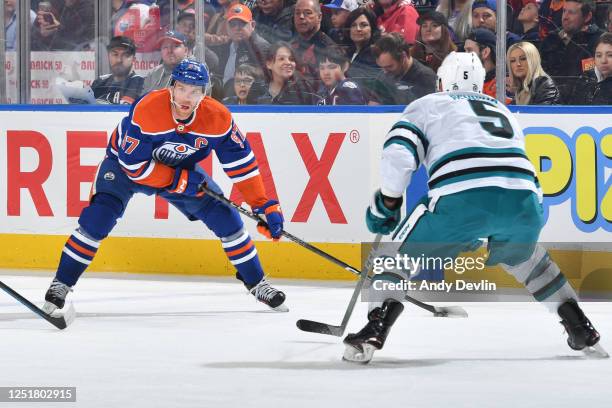 Connor McDavid of the Edmonton Oilers skates against Matt Benning of the San Jose Sharks during the game on April 13, 2023 at Rogers Place in...