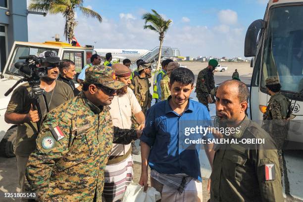 Yemeni Huthi rebel prisoners are released during a prisoner exchange with the internationally recognised-government, on their way to board a flight...