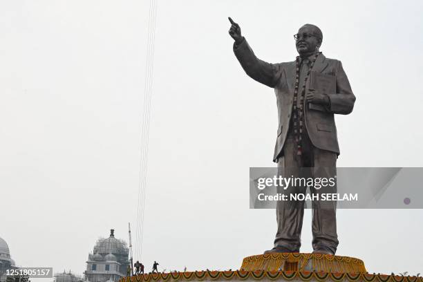 Workers decorate a 38-metre-tall statue of Indian social reformer Bhimrao Ramji Ambedkar, which was inaugurated on the occasion of his birth...