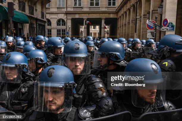 Riot police guard the Constitutional Council building during a demonstration against pension reform in central Paris, France, on Thursday, April 13,...