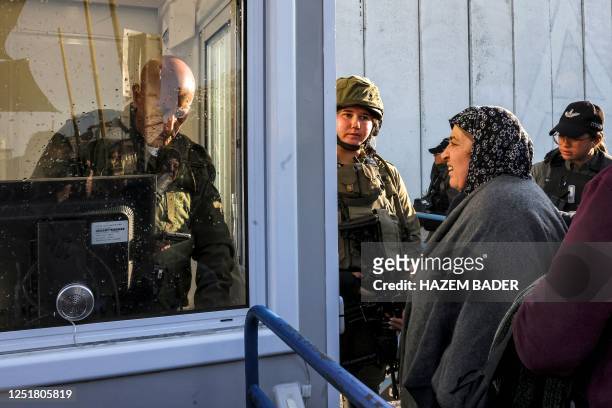 Palestinian woman waits at an Israeli checkpoint in Bethlehem in the occupied West Bank on April 14 awaiting to be allowed to cross to attend the...