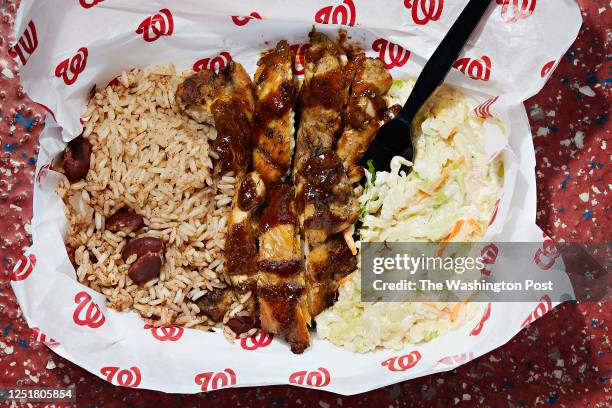 Jammin' Island BBQ jerk chicken combo with Jamaican rice and peas and Jammin' coleslaw at Nats Park photographed in Washington, DC on April 5, 2023. .