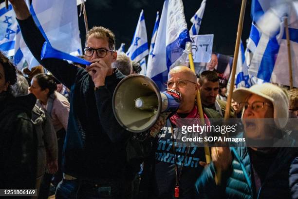 Anti reform protesters chant slogans hold Israeli flags and use the vuvuzela during the demonstration. Pro and Anti-judicial reform protesters...