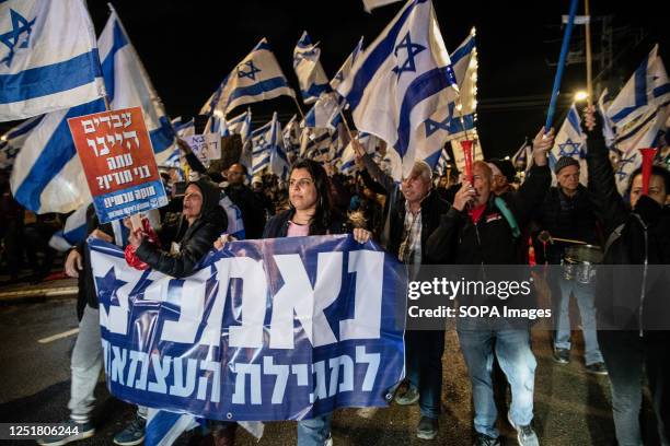 Anti reform protesters wave Israeli flags chant slogans and use vuvuzelas during the demonstration. Pro and Anti-judicial reform protesters...