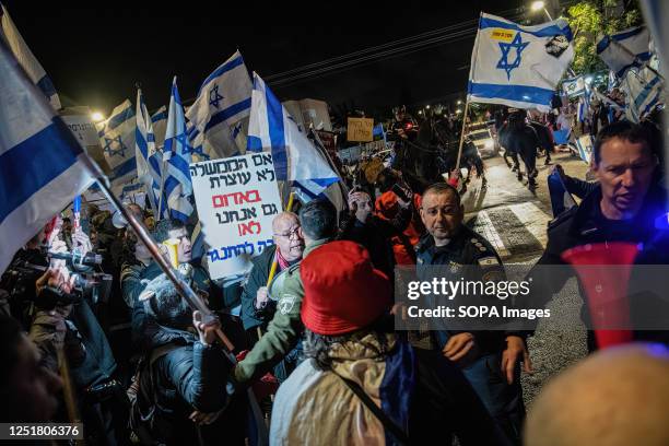 Israeli police officers and mounted police push back anti reform protesters from the road during the demonstration. Pro and Anti-judicial reform...