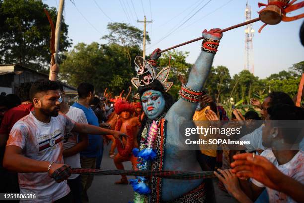 Hindu devotee dances as he takes part in a festival called Lal Kach during the last day of the Bangla month in Munshigonj outskirt of Dhaka. The...