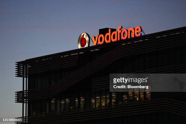 Sign on the roof of the Vodafone Group Plc regional headquarters at night in Madrid, Spain, on Thursday, April 13, 2023. Vodafone's Spanish business,...