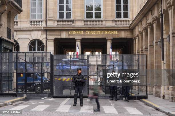 Police officers guard the Constitutional Council building in central Paris, France, on Friday, April 14, 2023. France's Constitutional Council will...