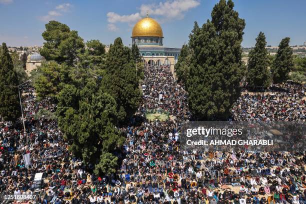 Palestinian Muslim worshippers attend the fourth Friday Noon prayer of the holy fasting month of Ramadan outside the Dome of the Rock mosque at...