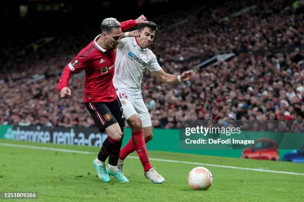 Antony of Manchester United and Marcos Acuna of Sevilla FC battle for the ball during the UEFA Europa League quarterfinal first leg match between...