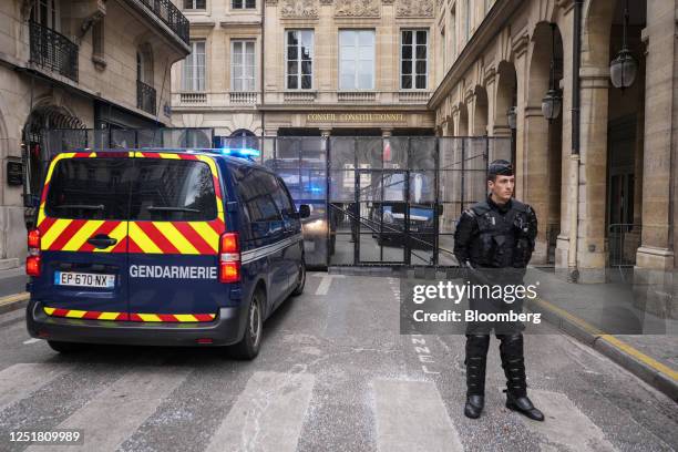 Police officers guard the Constitutional Council building in central Paris, France, on Friday, April 14, 2023. France's Constitutional Council will...