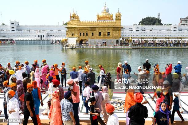 Sikh devotees gather at the Golden Temple during 'Baisakhi' a spring harvest festival, in Amritsar on April 14, 2023.