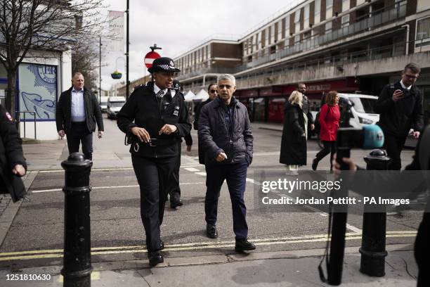 Mayor of London Sadiq Khan and Metropolitan Police Commander Dr Alison Heydari, with officers from the Met, during a visit to an estate in...