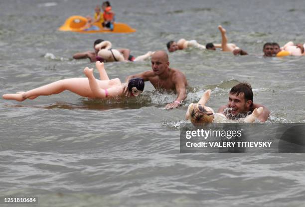 Men take part in a swimming competition on inflatable dolls during the "Rubber Baba Challenge 2010" outside the Siberian city of Novosibirsk on...