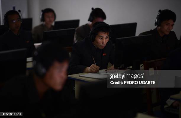 North Korean worker checks a computer at the control room of a textile factory in Pyongyang on April 9, 2012. North Korea is counting down to the...