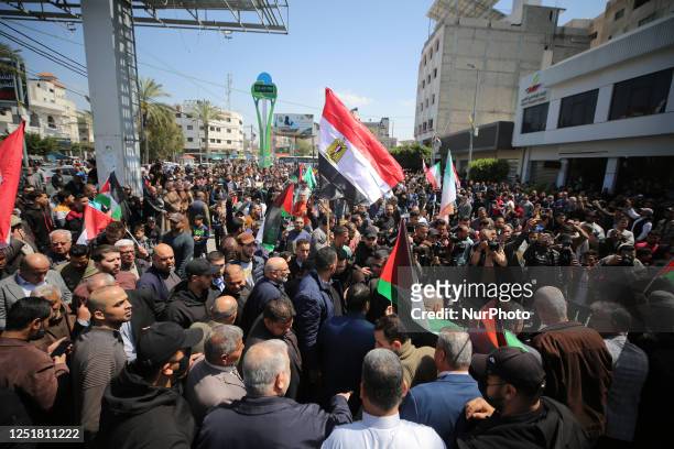 Palestinians wave flags during a protest held to mark Al-Quds Day, a commemorative day in support of the Palestinian people celebrated annually on...