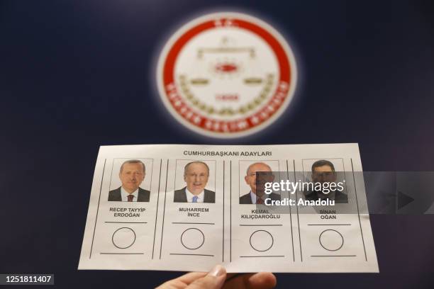 Person holds the ballot displaying presidential candidates in front of the logo of "Supreme Election Council" ahead of the presidential and...