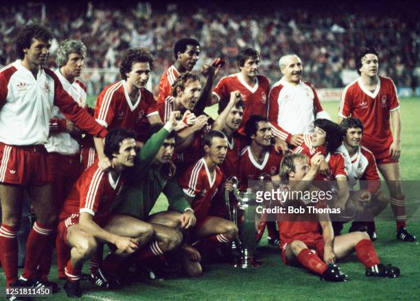 Nottingham Forest line up for a group photo as they celebrate with the trophy after winning the European Cup final between Nottingham Forest and...