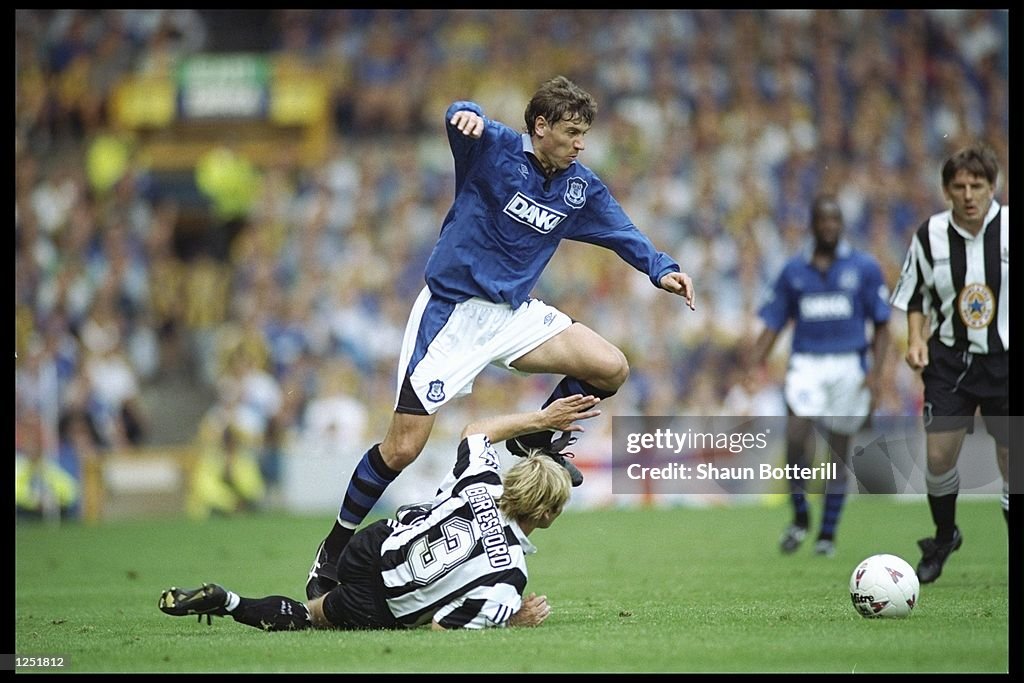 Andrei Kanchelskis of Everton skips over a challenge from John Beresford of Newcastle