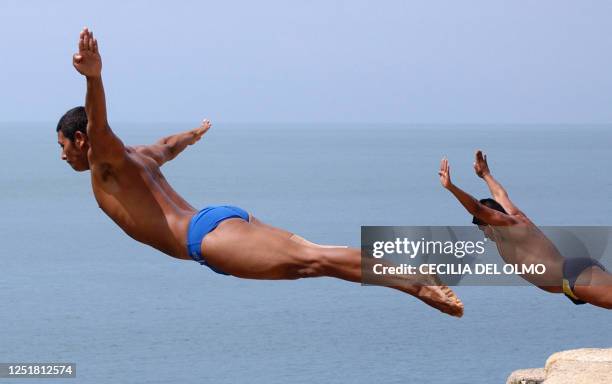 Two cliff divers jump from "La Quebrada" cliff in Acapulco, Mexico, on September 30th, 2007. The tradition of "La Quebrada" goes back to 1934, when...