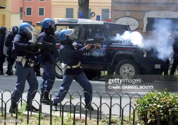 Security forces shoot tear gas on anti-globalization activists during a rally against the Group of Eight summit in Genoa 20 July 2001. Leaders from...