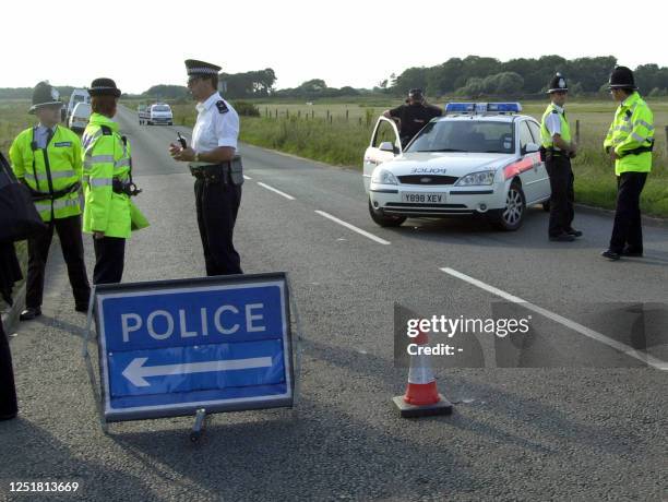 Police guard the area around Wangford church where the bodies of the two missing girls Holly Wells and Jessica Chapman were presumed found in the...