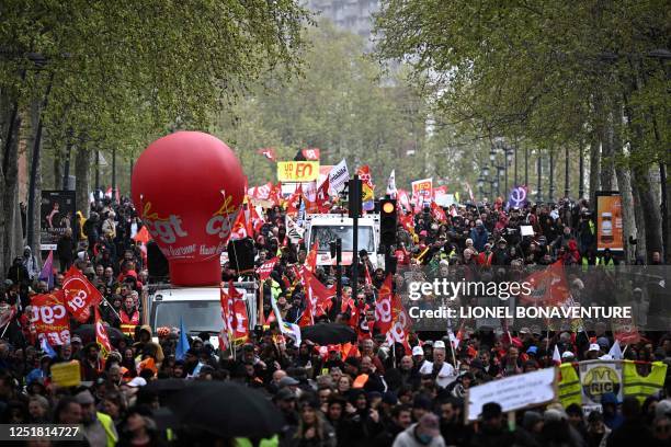 People take to the streets during a demonstration on the day of a ruling from France's Constitutional Council on a contested pension reform pushed by...