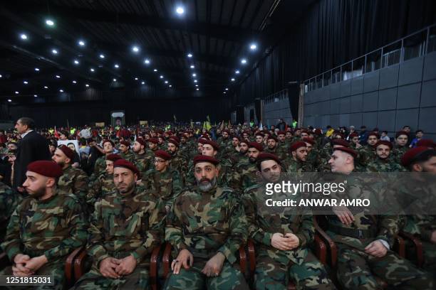 Militants with the Lebanese Shiite movement Hezbollah, gather to watch on a large screen a speech by the leader of the group, in Beirut's southern...