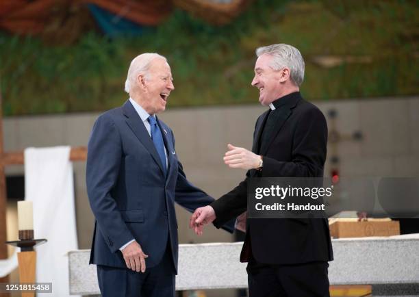 In this handout image provided by the Irish Government, US President Joe Biden visits Knock Shrine and Basilica with Fr. Richard Gibbons on April 14,...