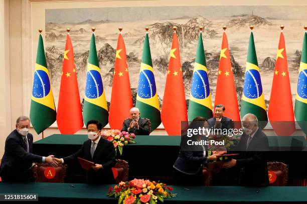 Brazilian President Luiz Inacio Lula da Silva and Chinese President Xi Jinping applaud during a signing ceremony held at the Great Hall of the People...