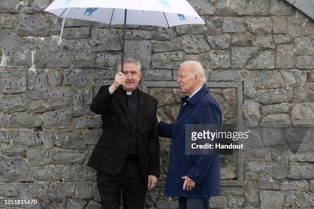 In this handout image provided by the Irish Government, US President Joe Biden visits Knock Shrine and Basilica with Fr. Richard Gibbons and touched...