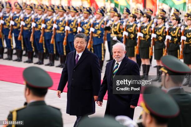 Brazilian President Luiz Inacio Lula da Silva inspects an honor guard with Chinese President Xi Jinping during a welcome ceremony held outside the...