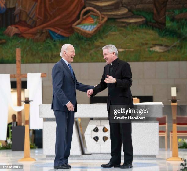 In this handout image provided by the Irish Government, US President Joe Biden visits Knock Shrine and Basilica with Fr. Richard Gibbons on April 14,...