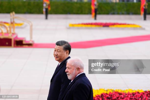 Brazilian President Luiz Inacio Lula da Silva and Chinese President Xi Jinping walk during a welcome ceremony held outside the Great Hall of the...