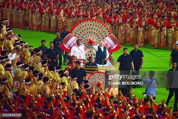 India's Prime Minister Narendra Modi and Assam's Chief Minister Himanta Biswa Sarma arrive to watch the Bihu dance performance at Sarusajai stadium...