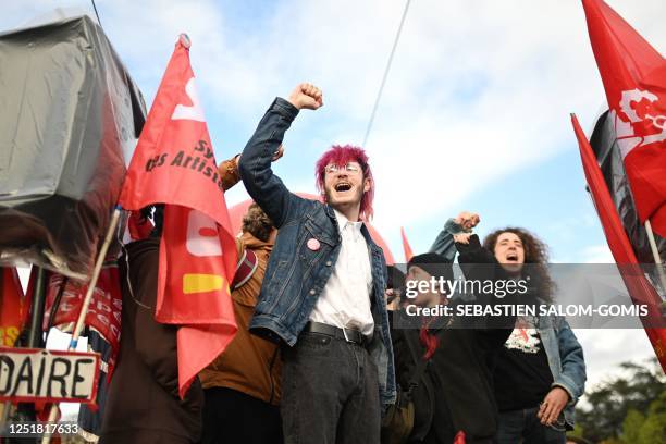 Young protesters raise their fist and shout slogans during a demonstration on the day of a ruling from France's Constitutional Council on a contested...