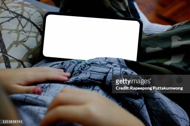 child watching smartphone with blank screen - horizontal stock-fotos und bilder