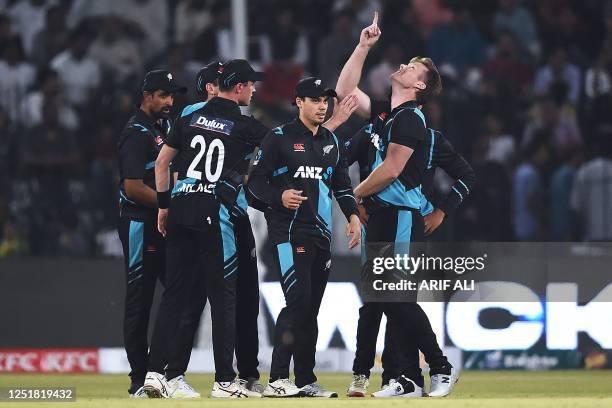 New Zealand's Jimmy Neesham celebrates with teammates after taking the wicket of Pakistan's Imad Wasim during the first Twenty20 cricket match...