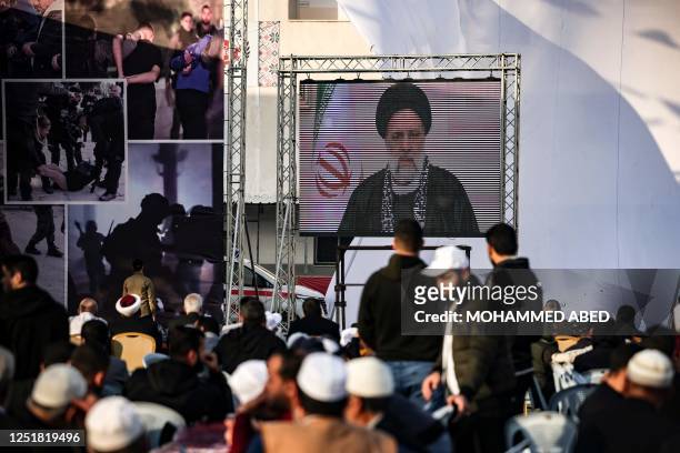 Iran's President Ebrahim Raisi delivers a televised speech during a rally marking Al-Quds Day, a commemoration in support of the Palestinian people...