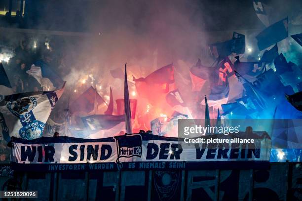 April 2023, North Rhine-Westphalia, Gelsenkirchen: Soccer: Bundesliga, FC Schalke 04 - Hertha BSC, Matchday 28, Veltins Arena: Berlin fans set off...